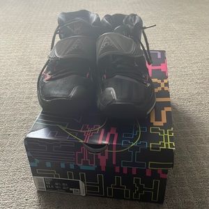 Kyrie 6’s are a Nike shoe, has the colors Black, Orange, and Light Blue.